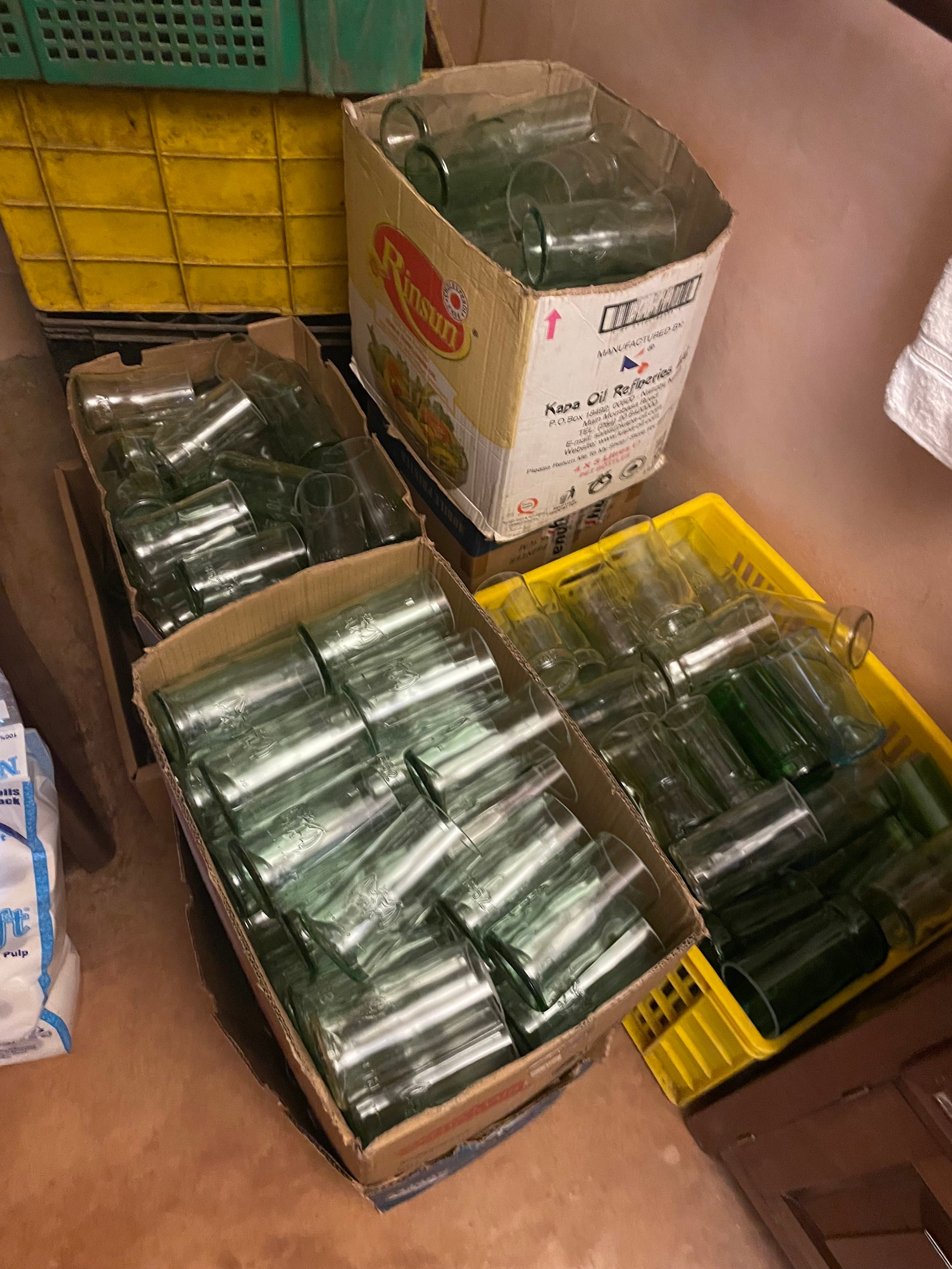 Boxes of drinking glasses cut from repurposed glass bottles
