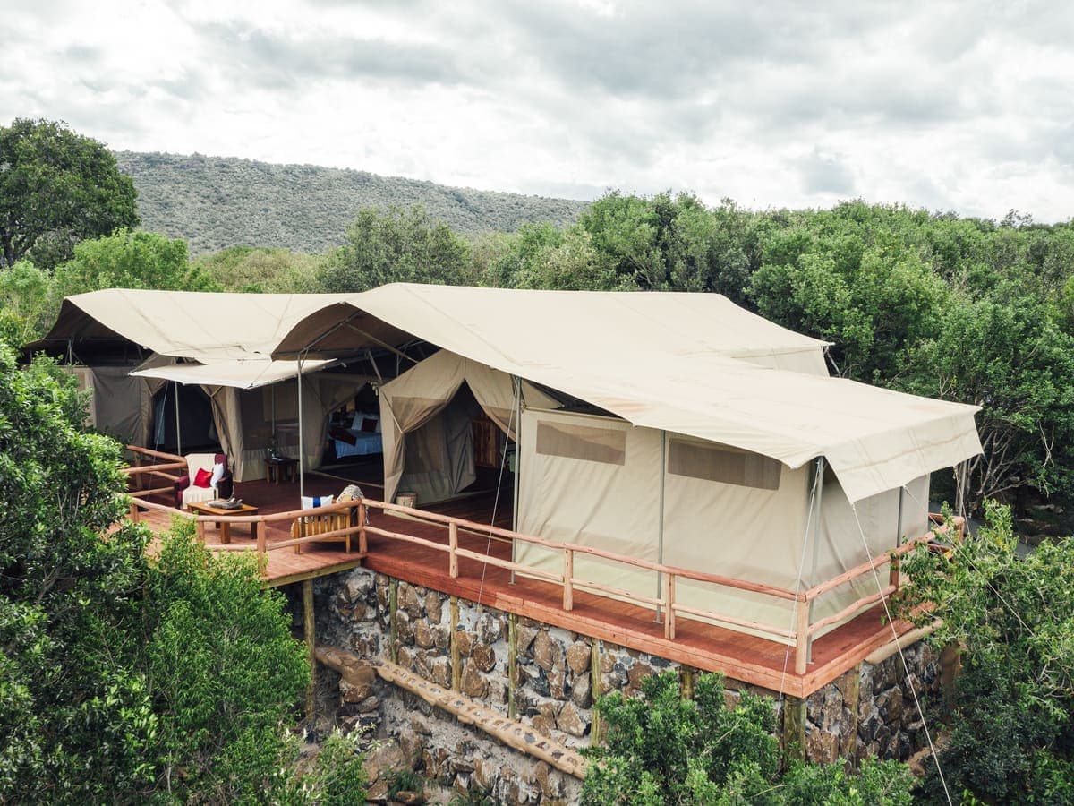 Canvas tents on raised wooden decks among the trees at Tangulia Mara